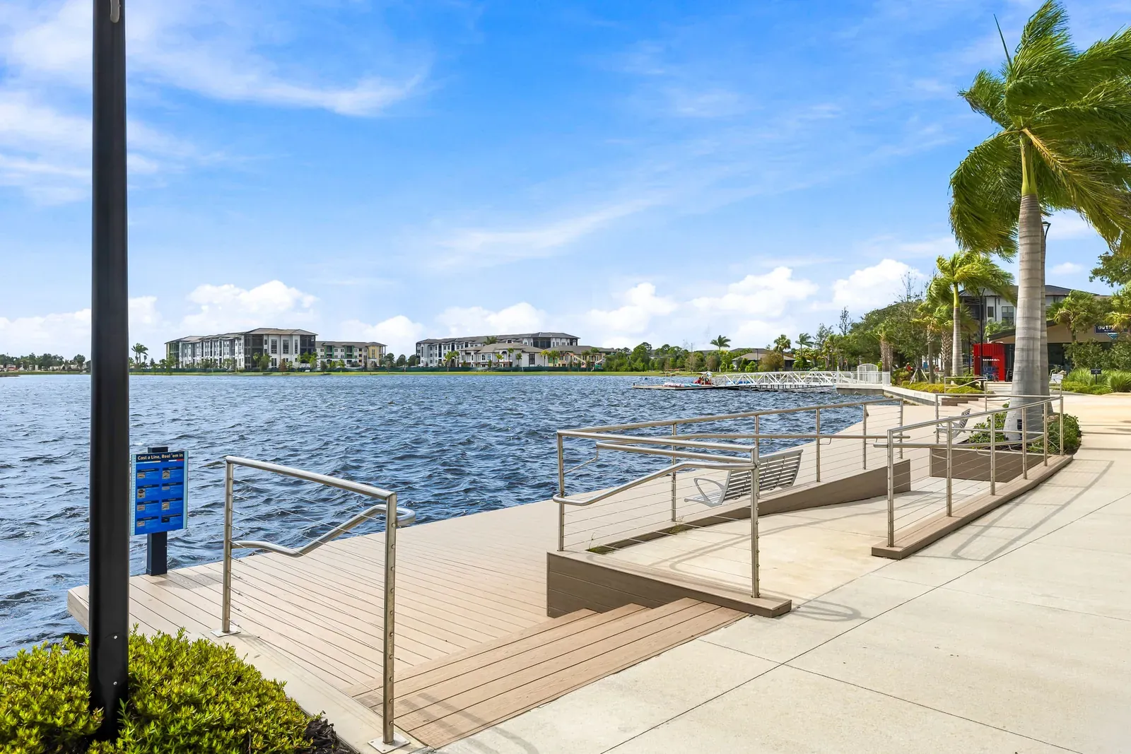 Waterfront deck with railings and broad steps leading down to the lake in Wellen Park